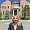Jackie Wegner smiles while posing outside of the Koelbel Building