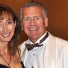 John Acker poses with his wife at a formal event