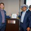 Nick Brown and Uriel Berrum holding their Dolphin Tank award