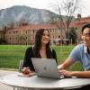 Julie Huang and Kevin Nguyen laugh while meeting at an outdoor table