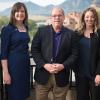 Four women surround Mark Meaney in a professional photo in front of the Flatirons.