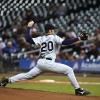 A baseball pitcher in No. 20 jersey readies to throw the ball.