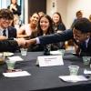 Members of the winning Business Leadership Program team celebrate their victory by fist bumping.