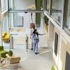 A woman shows a modern office space to a professional.