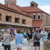 The Rustandy Building with students and parents enjoying the weather outdoors.