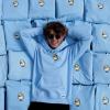 Rylan Montoya Laying in a pile of DumbClub Sweatshirts