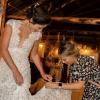 Sarah Lurie fixing a dress for a bride