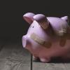 A piggy bank with bandages on it.