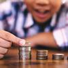 young-child-stacking-coins-banking-research
