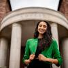 Trisha Tyagi smiles at the camera while posing on campus.