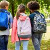 elementary school students walking away from the camera