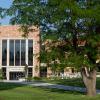 Exterior of the Koelbel and Rustandy buildings on the CU Boulder campus on a summer afternoon.