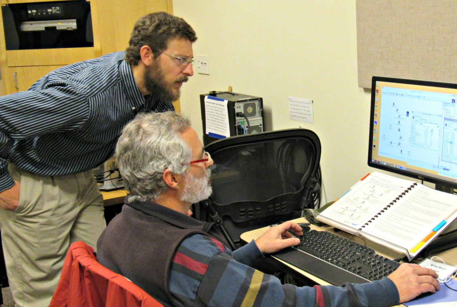 Instructor assisting a class attendee