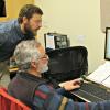 instructor assisting a student at the computer
