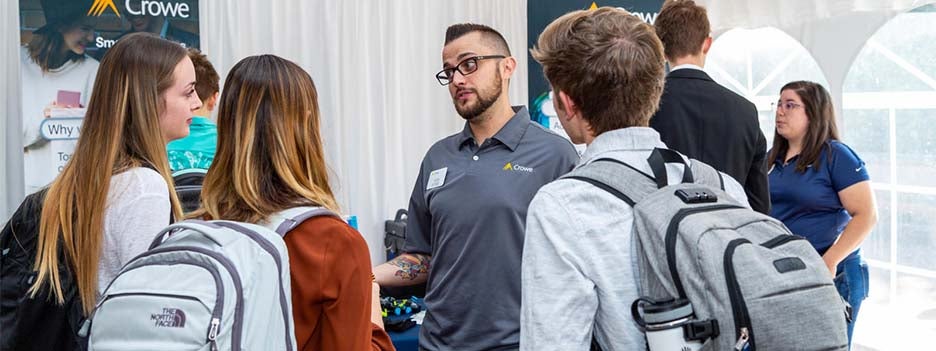 person talking to students at a career fair