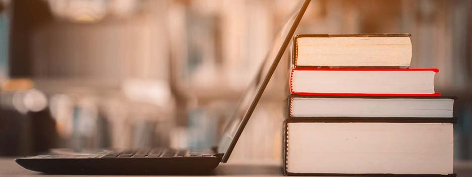 laptop and stack of books