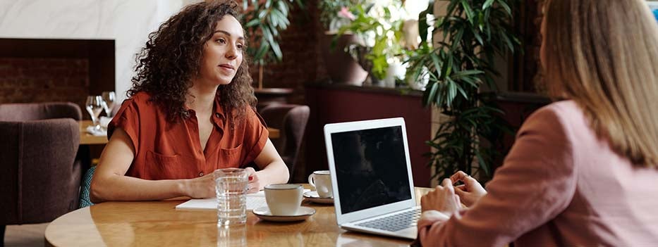 two women talking in a coffee shop