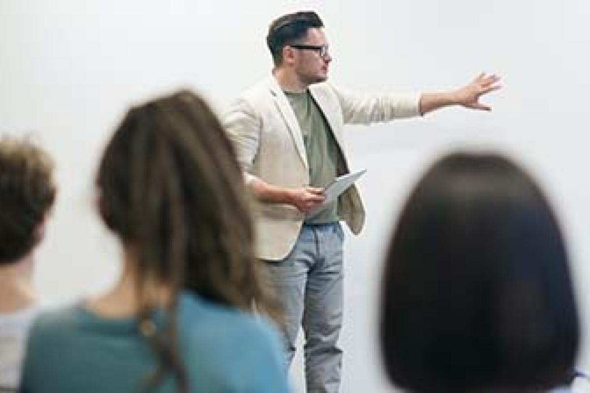 man standing in front of a classroom