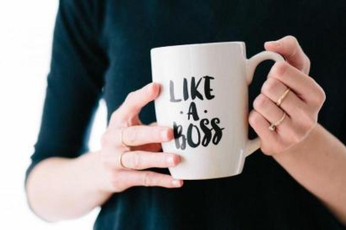 person holding a mug that says "like a boss"