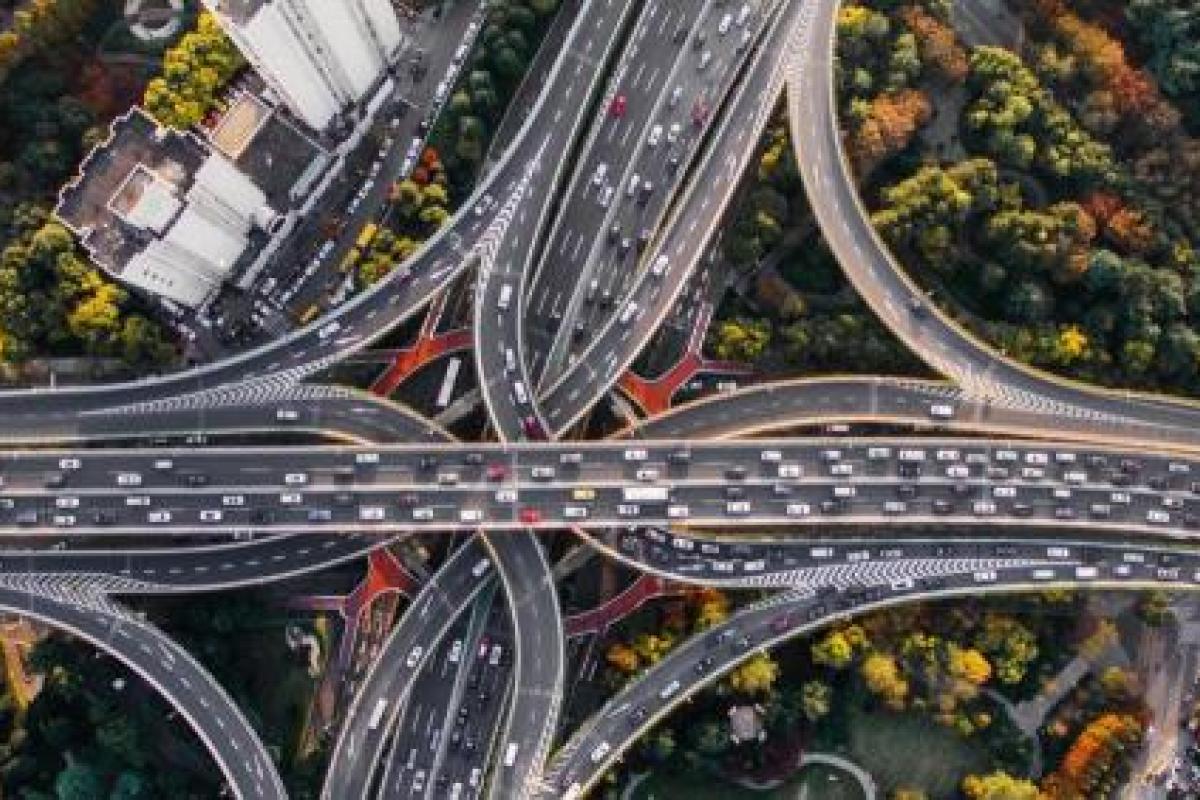 busy highway interchange with a lot of cars driving