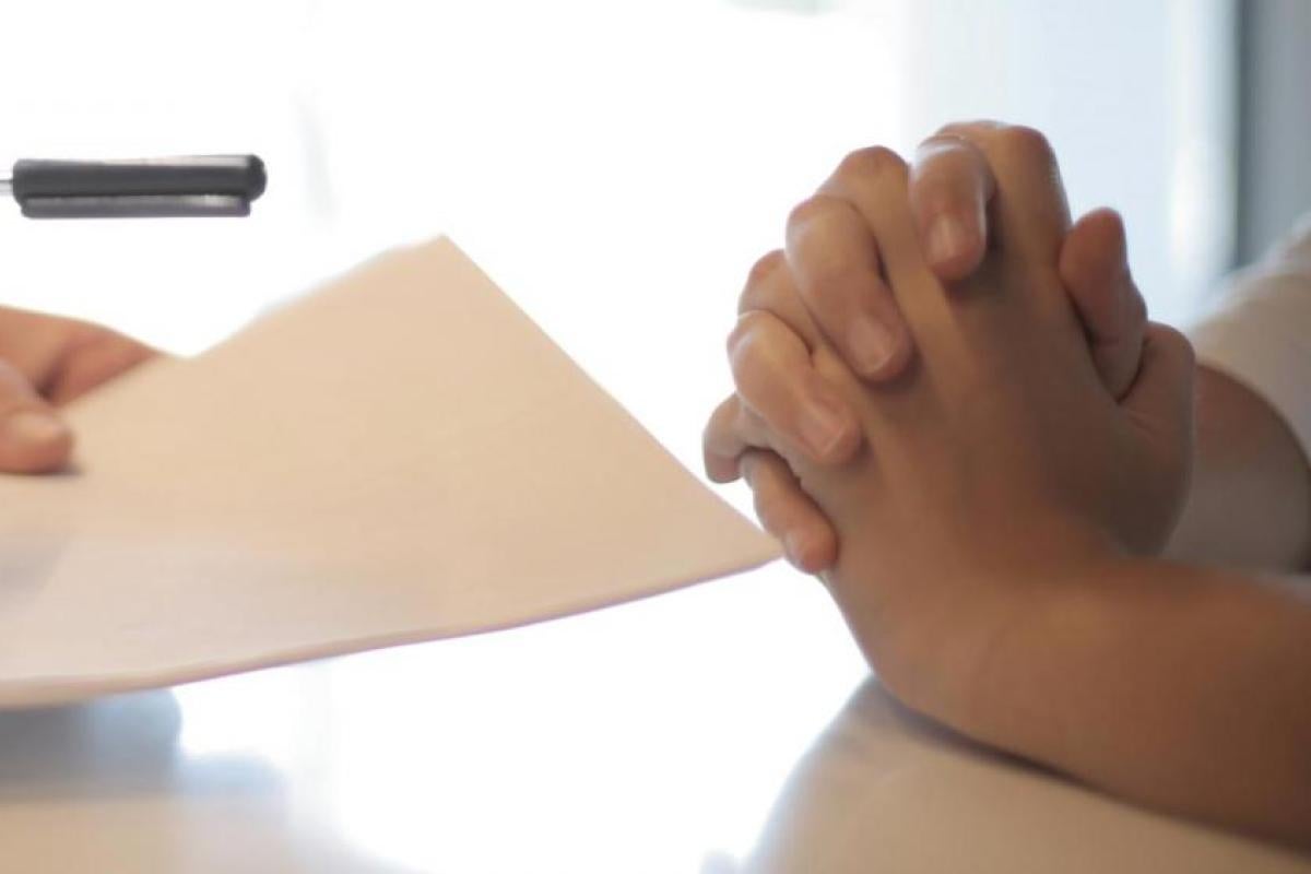 person pointing with a pen