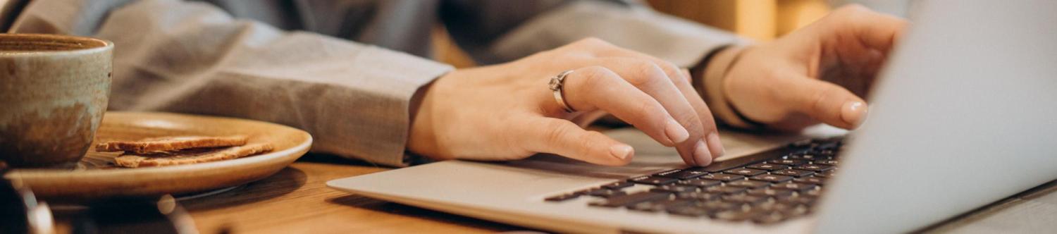 person typing on laptop keyboard