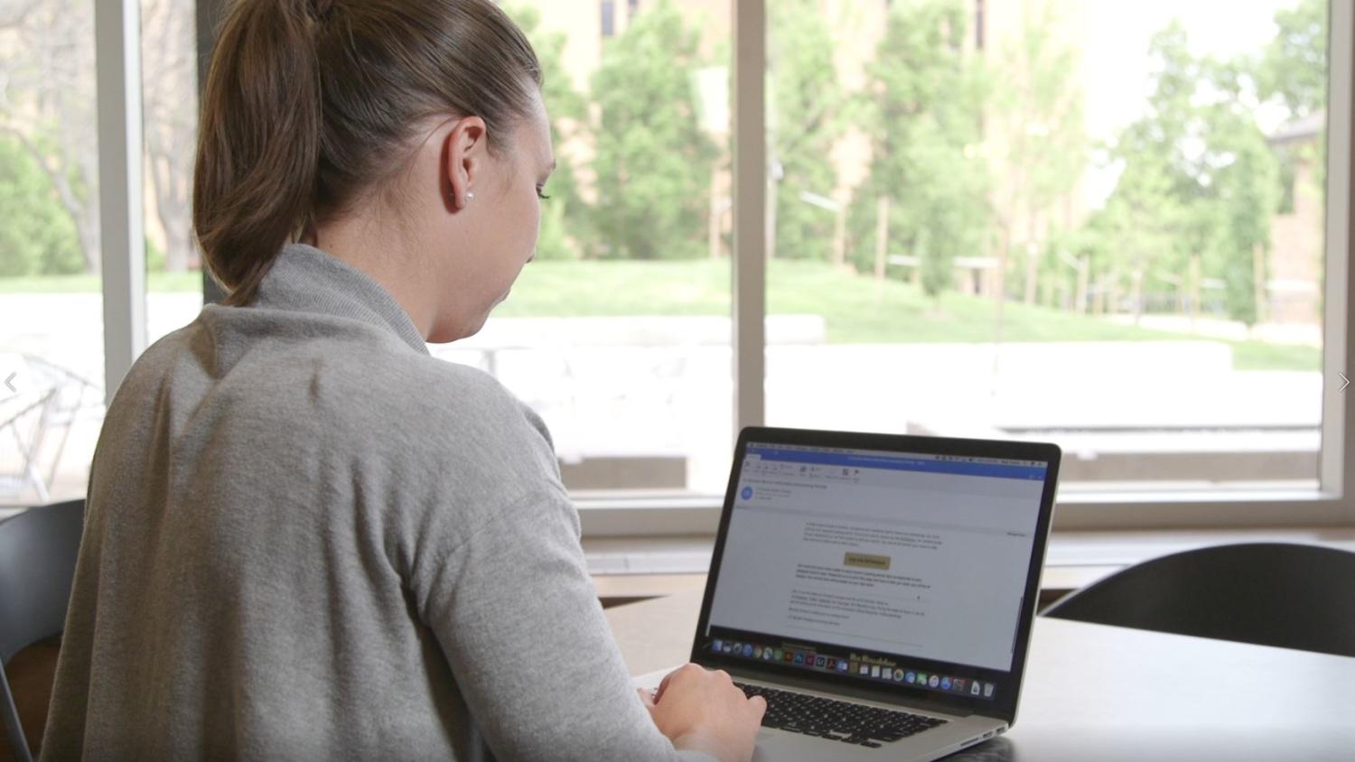 a student typing on a laptop