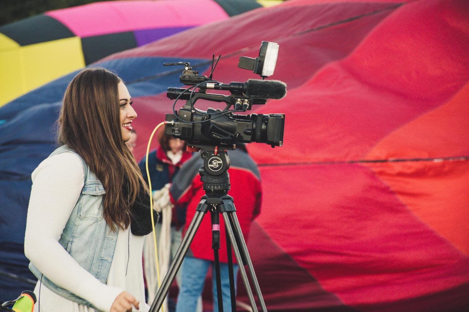 woman standing behind a camera