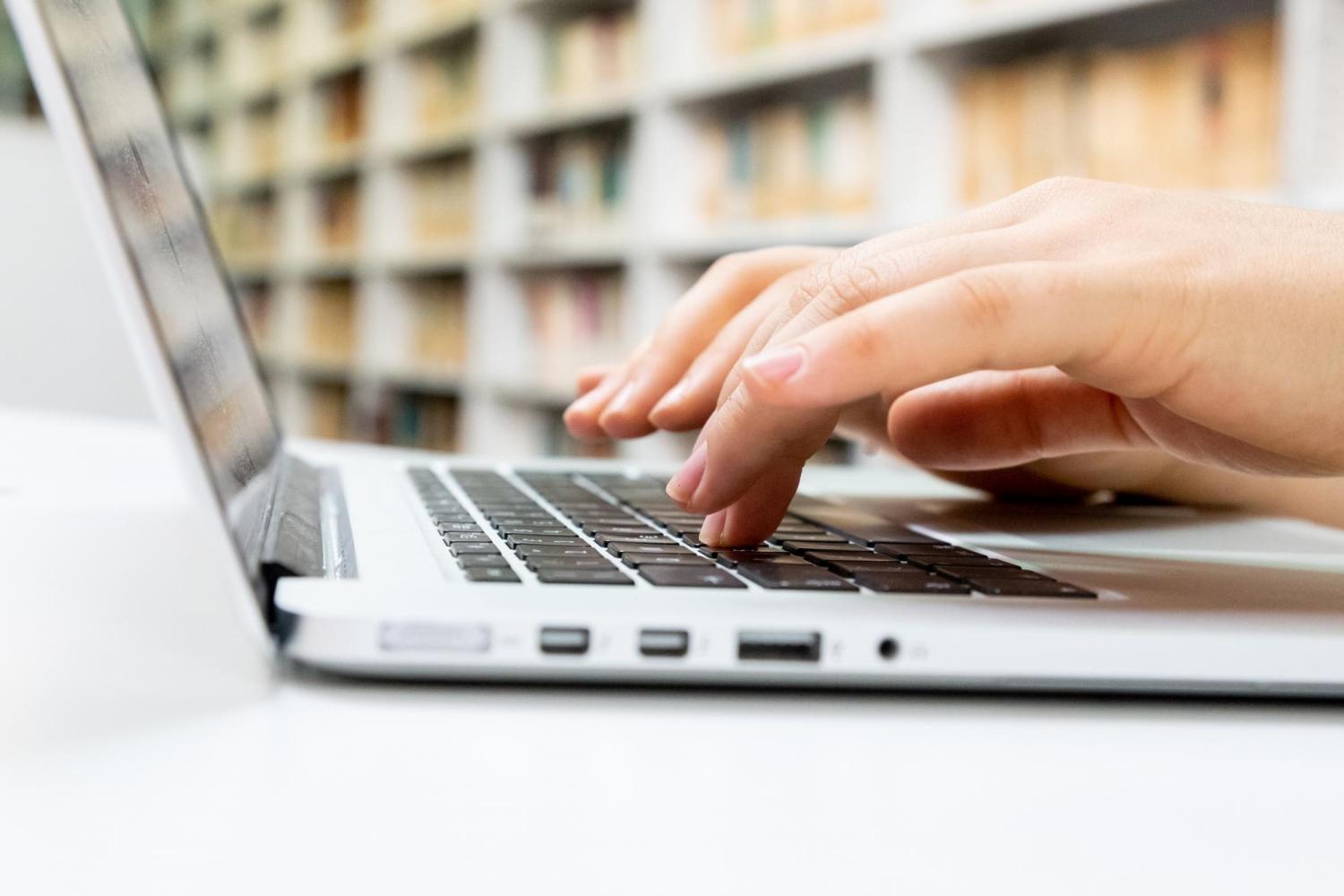 person typing on a laptop