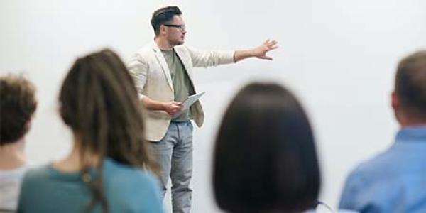 man standing in front of a classroom