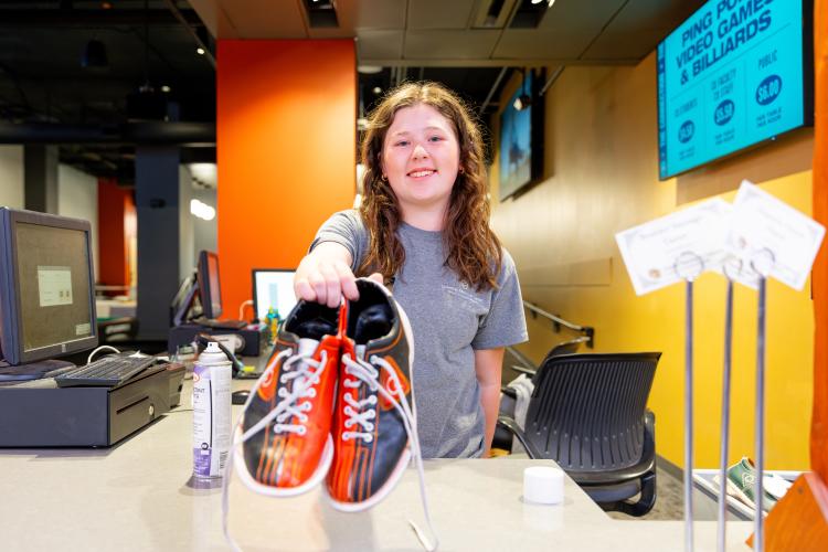employee handing out shoes at Connection