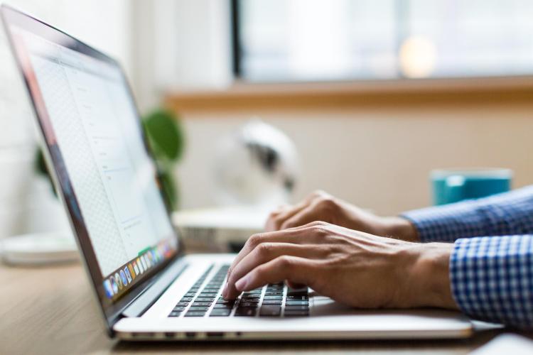 person typing on a computer
