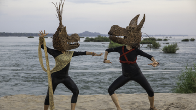 two people dancing with dragon masks