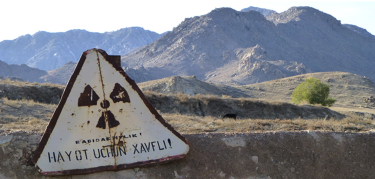 nuclear warning in front of mountains