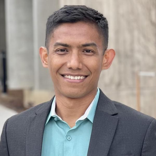 Ilham Siddiq in a suit jacket and a casual shirt underneath.