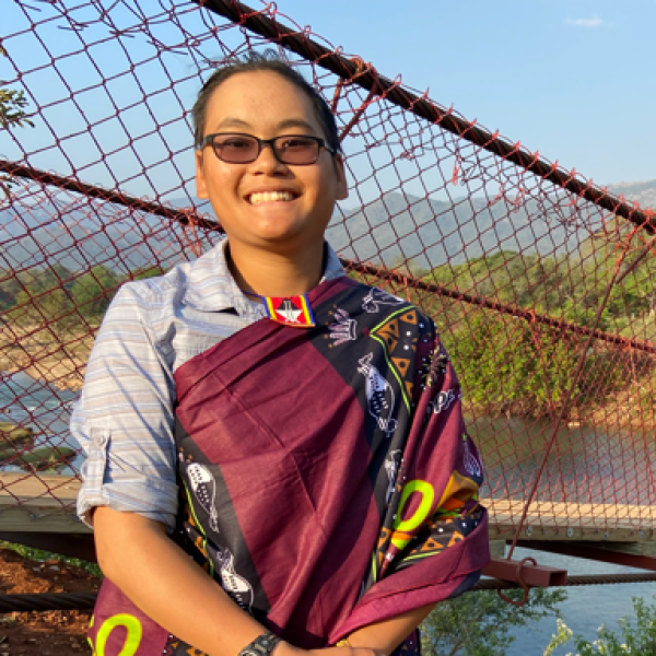 Nina Fromartz next to a long suspension bridge.