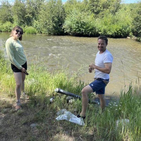 Kat Demaree and Jason Quinn installing an in-situ water quality tool