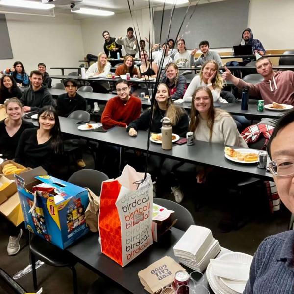 John Zhai in front of his his classroom