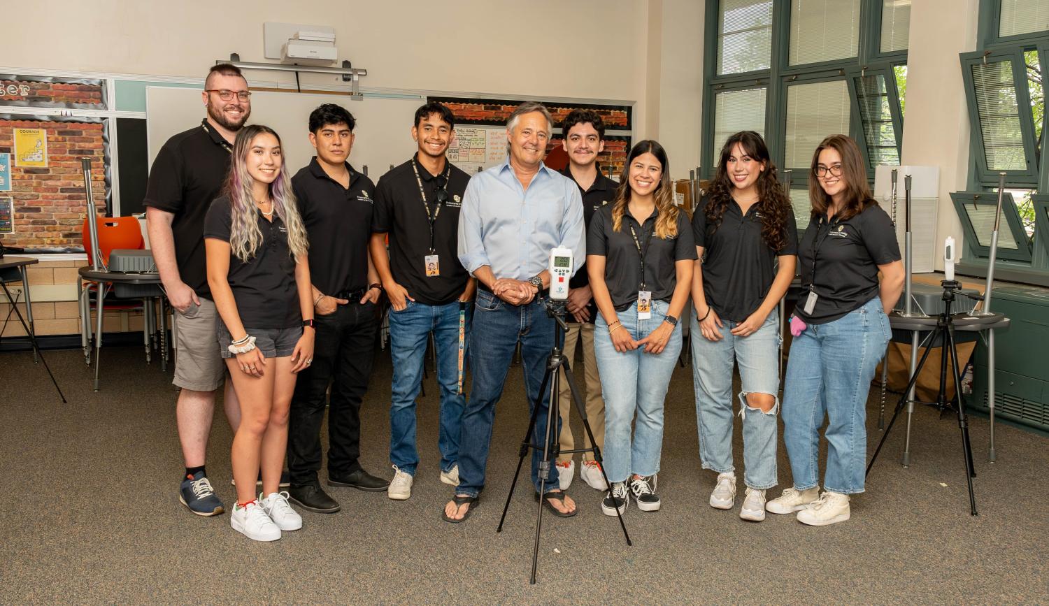 Mark Hernandez and his 2024 Air Quality Testing students with a monitor