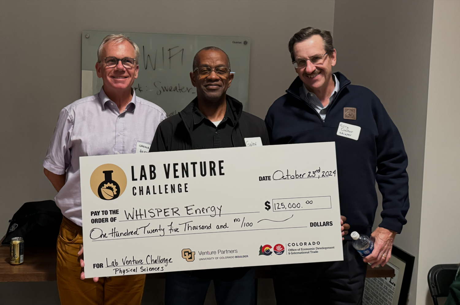 Gregor Henze and his startup partners hold a large-sized check from Lab Venture