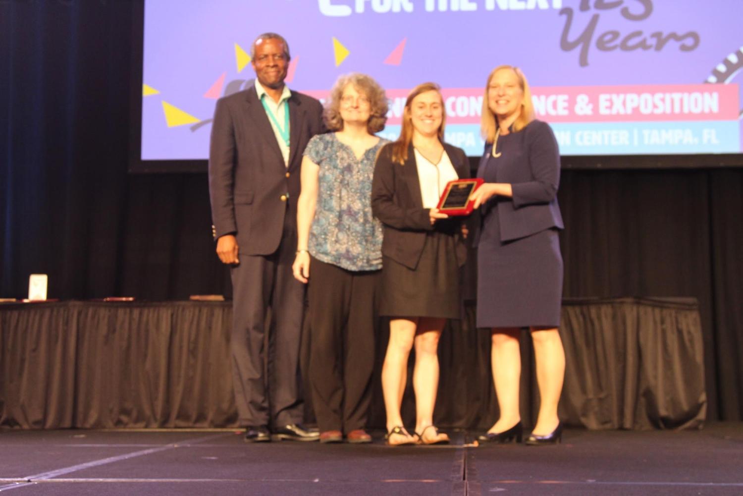 Bielefeldt and Polmear receive their award onstage from Chris Swan of Tufts University and ASEE President Stephanie Farrell.