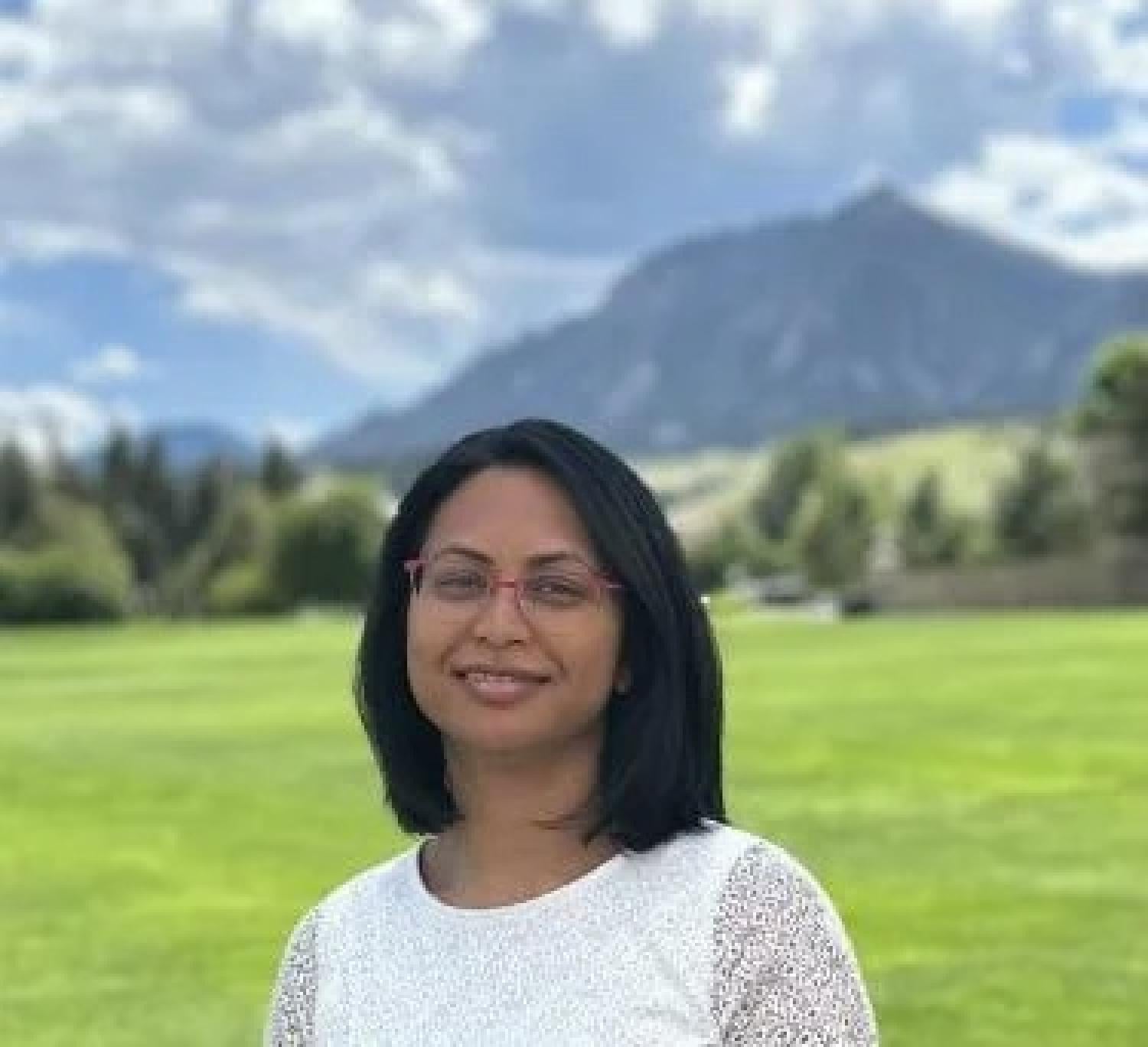 Aditi Bhaskar with the Flatirons blurred in the background.