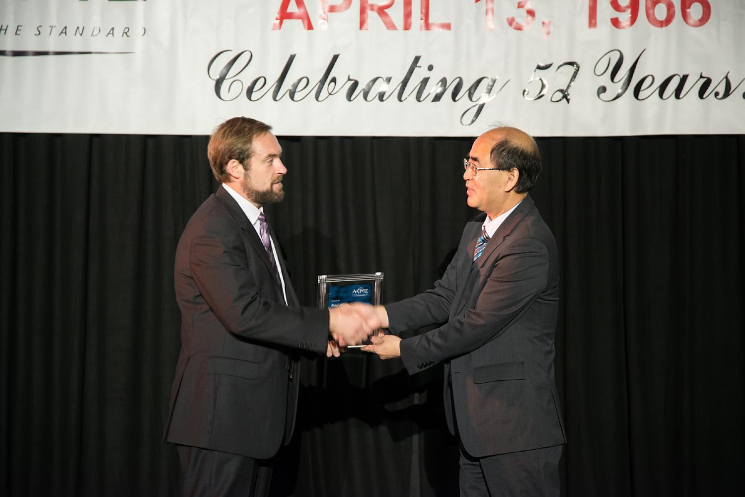 Brad Wham receives his award on stage at the 2018 Pressure Vessels and Piping Conference in Prague.