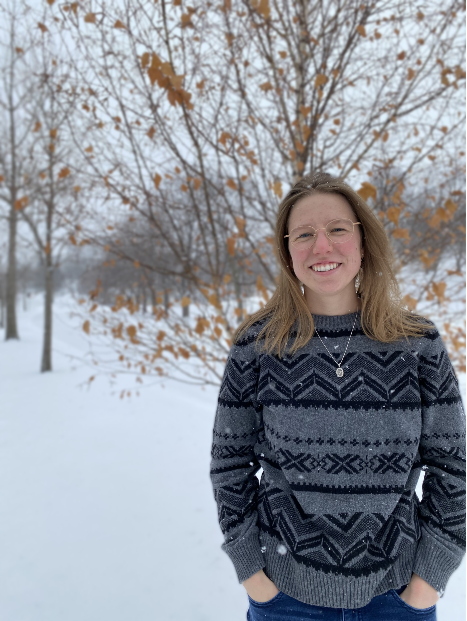 Madelline Pernat in a sweater with snow on the ground.