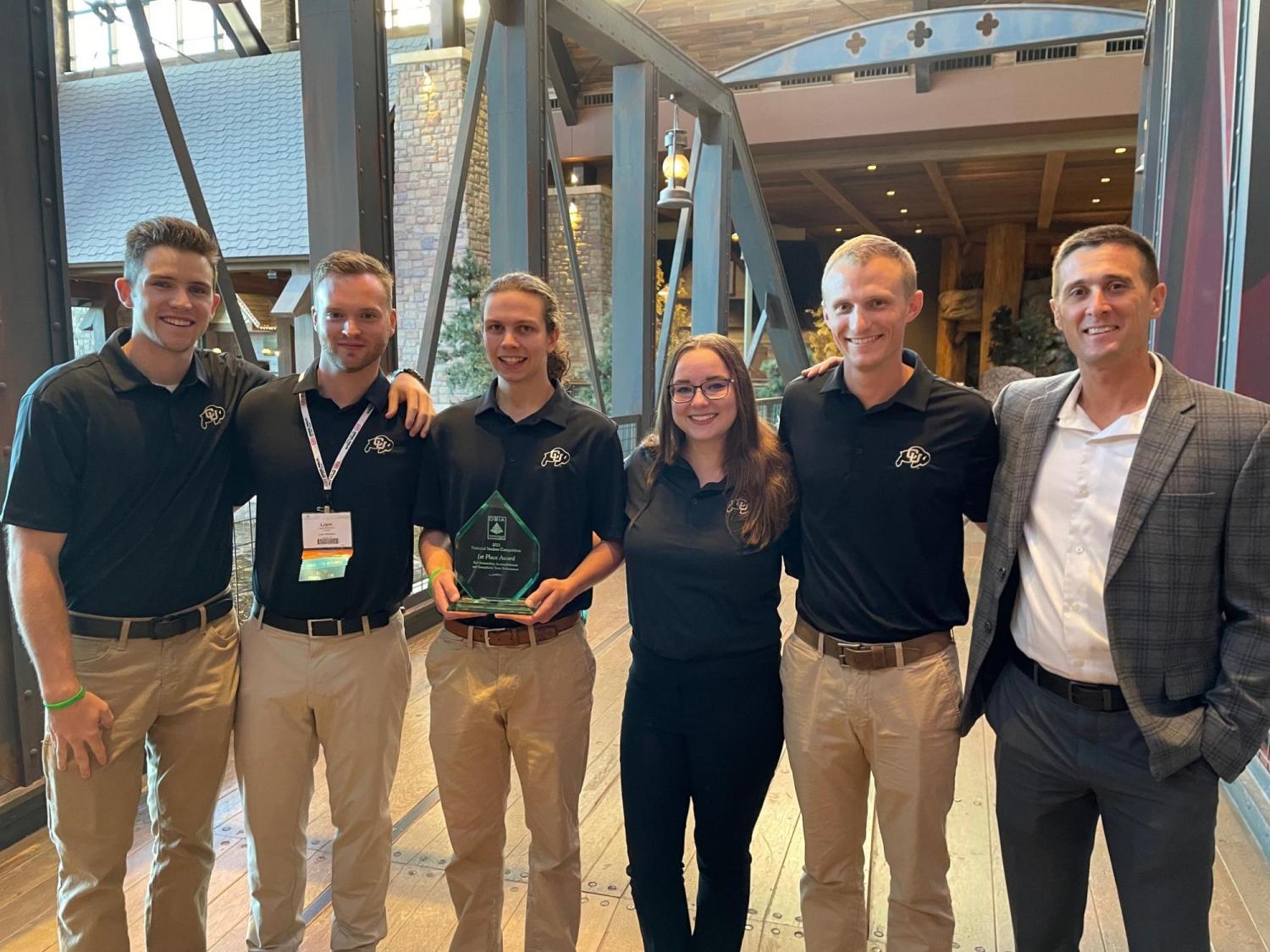 Members of CU Boulder's Design Build Institute of America holding trophies.