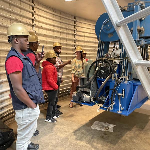 EIA visitors in  hardhats at site visit