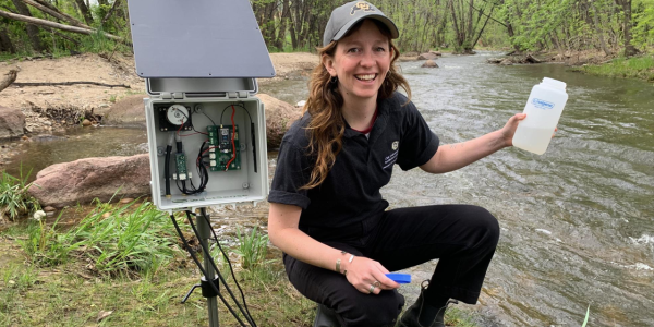 CU student testing creek water