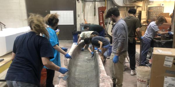 Adding concrete to the mold.