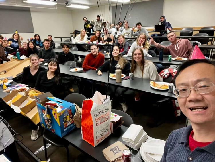 John Zhai in front of his his classroom