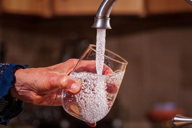 Pouring water into a glass.